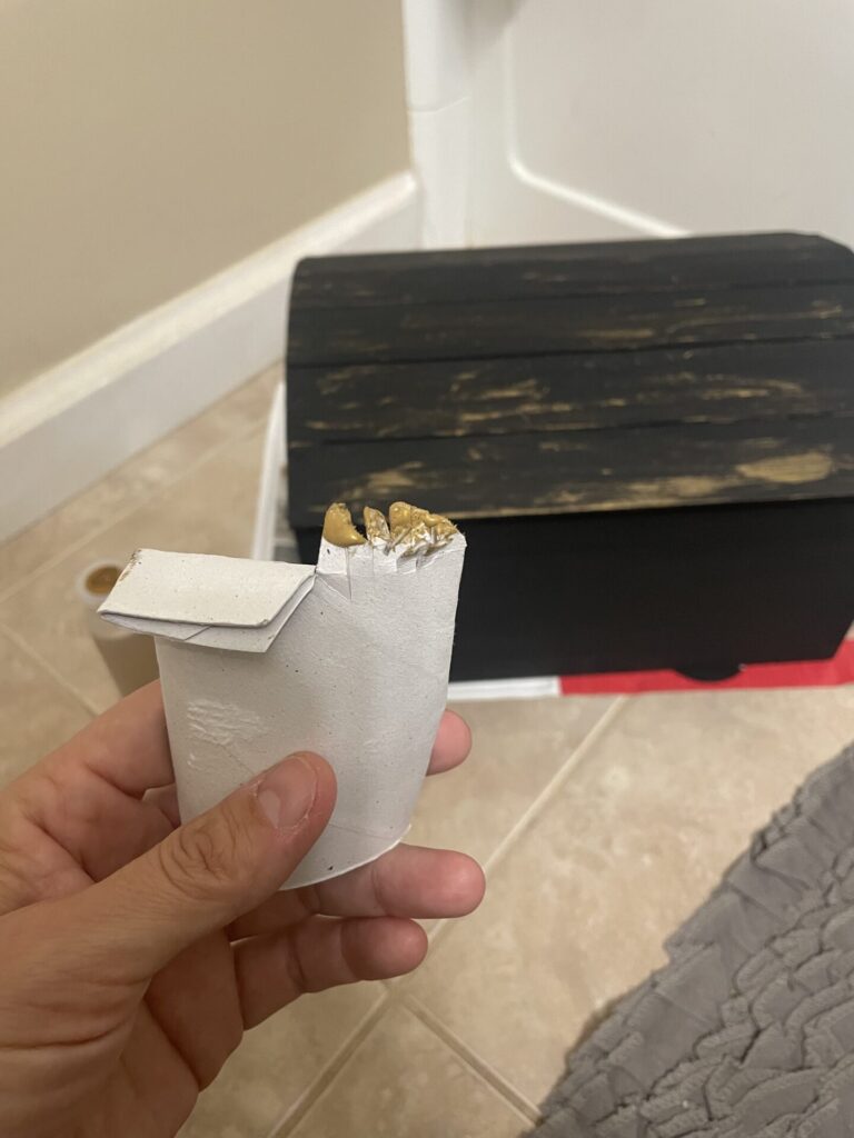 Using a toilet paper roll with a few small cuts to one side to give a scratchy gold color on the treasure chest.