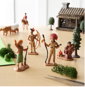 Gift Idea for kids, a plastic tube filled with toys of cowboys and indians