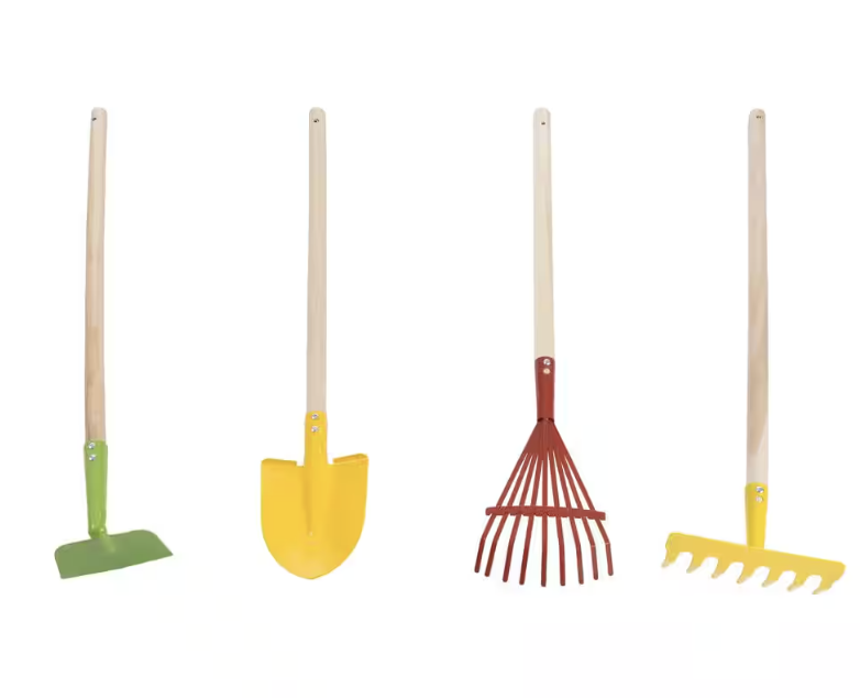 A set of kids yard tools with wooden handles. A red rake, a yellow rake, a yellow shovel and a green hoe