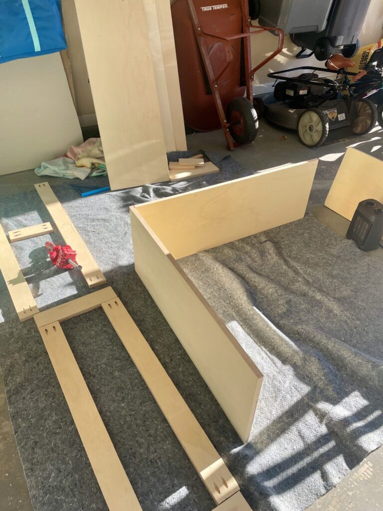 Plywood pieces being assembled to a box