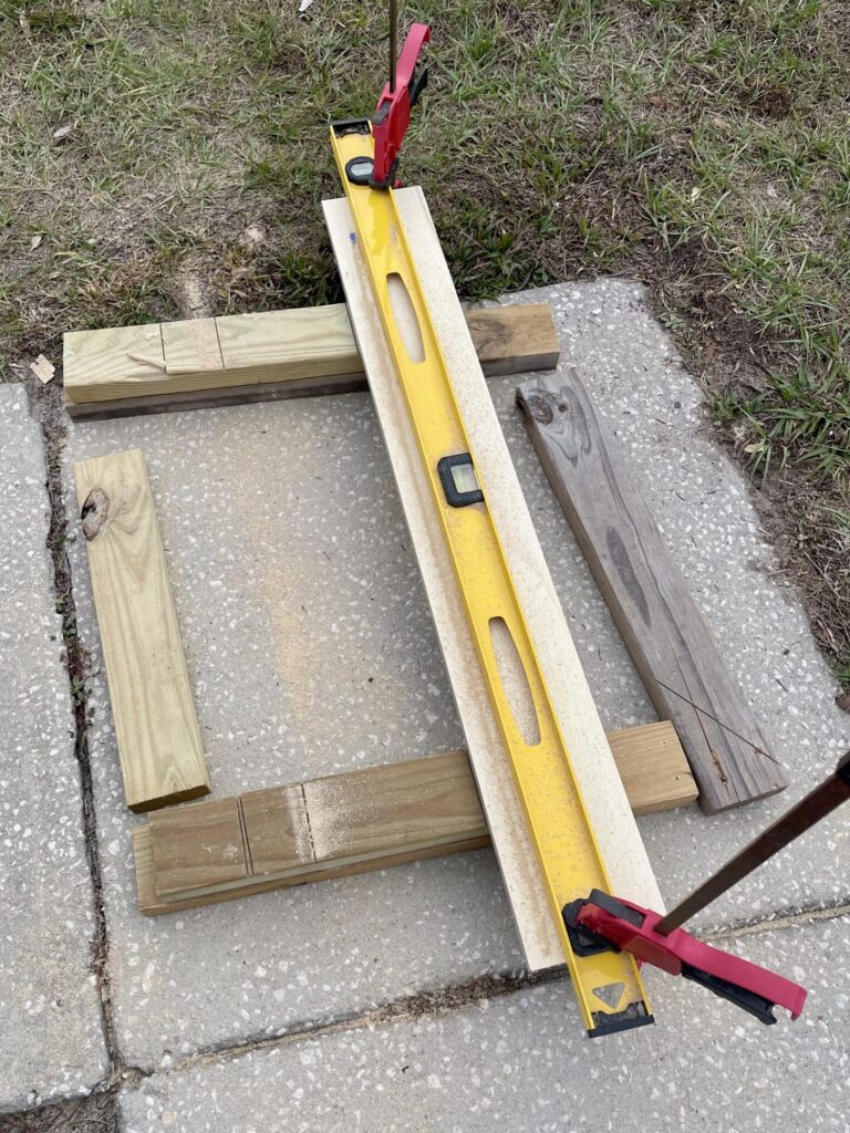 DIY circular saw guide made by clamping a level against a piece of wood